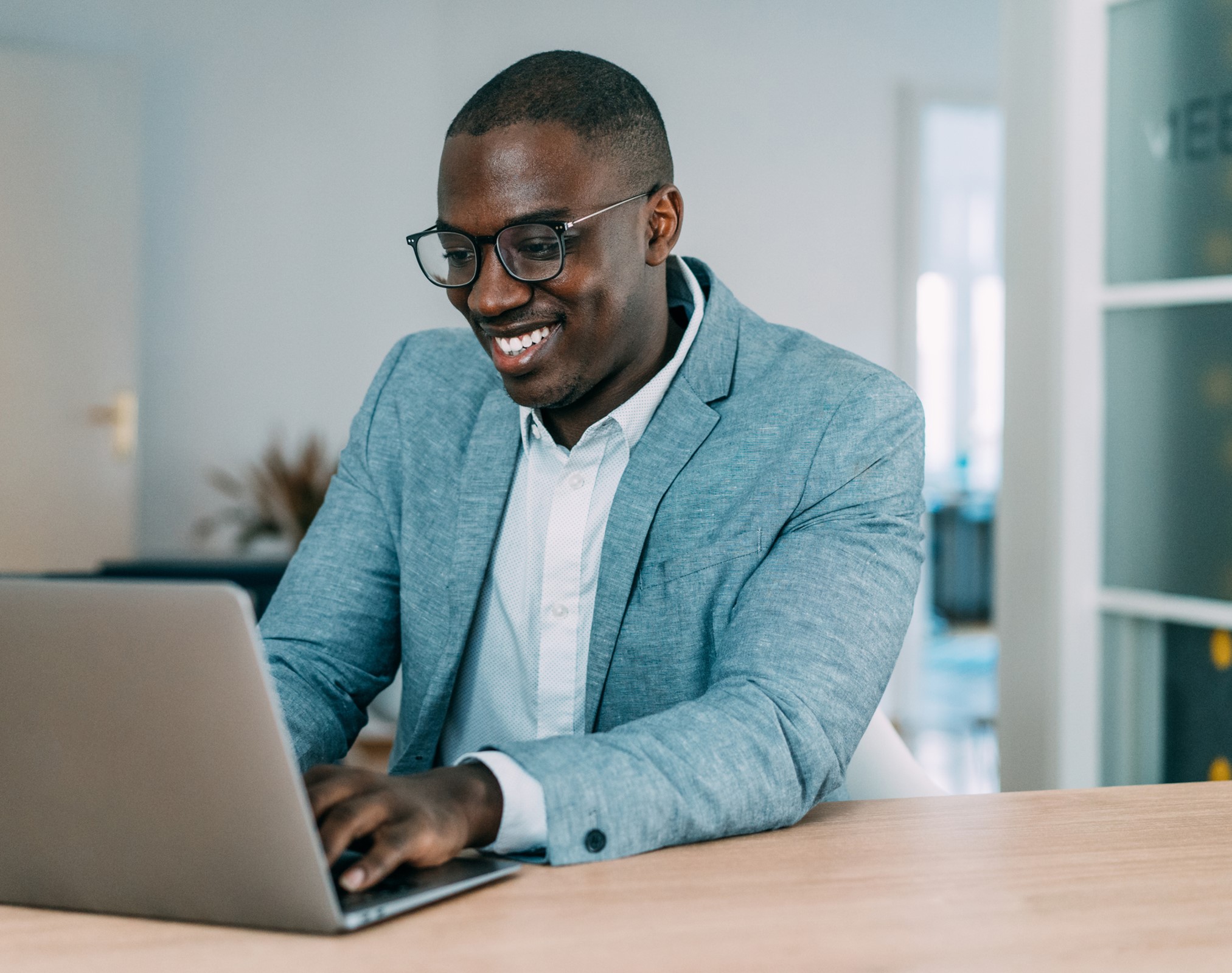 smiling business man working on laptop